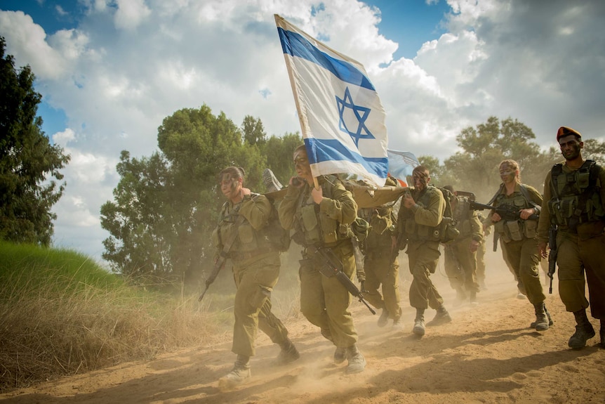 A group of Israeli solders carry a stretcher.