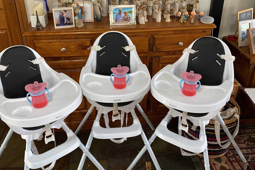 Three high chairs with bottles.