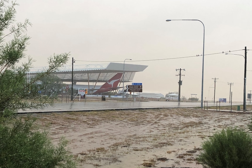 A Qantas plane under cover during rain at Longreach.