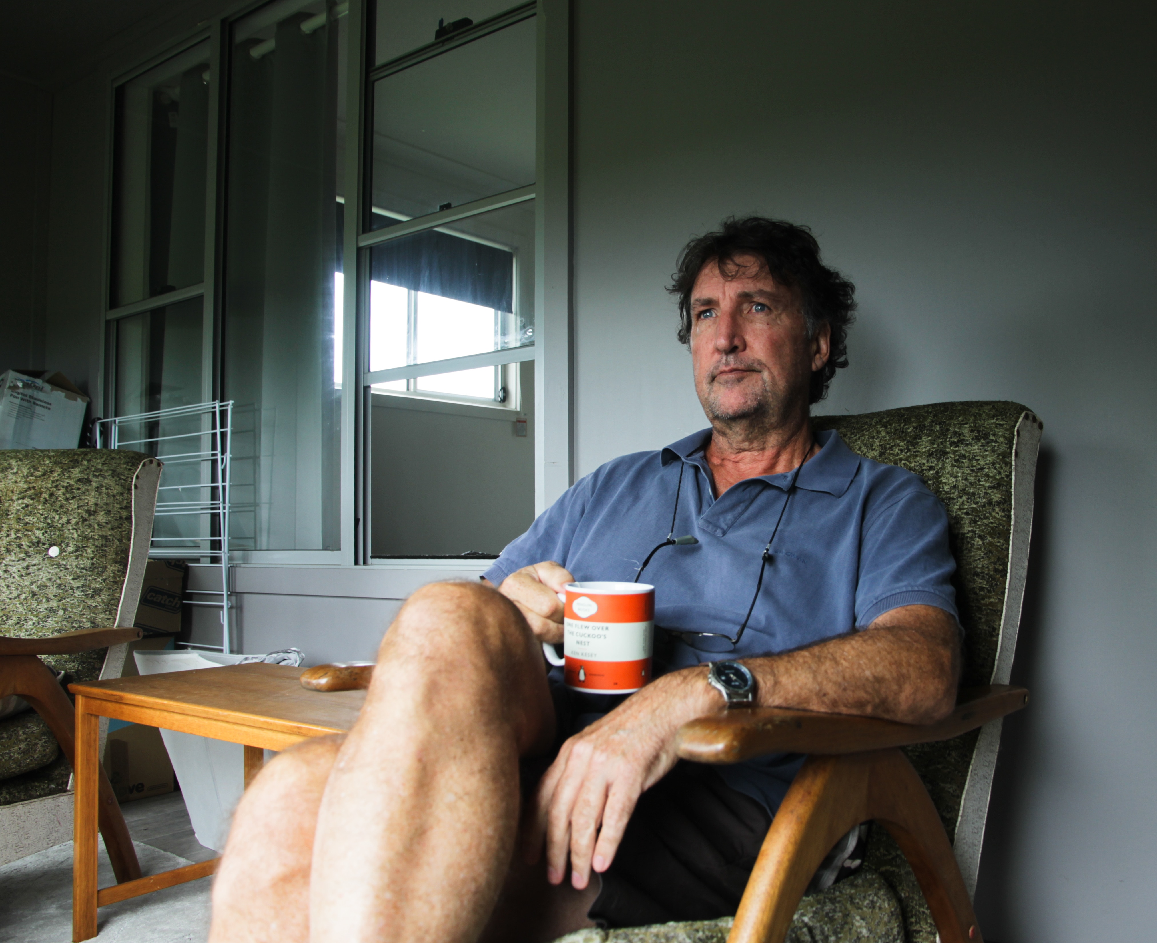 A man sitting in a chair sipping tea