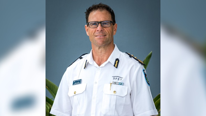 A man in a white DFES dress uniform named Rick Curtis smiles for the family. 