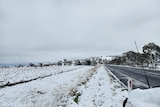 snow on the road side and hills