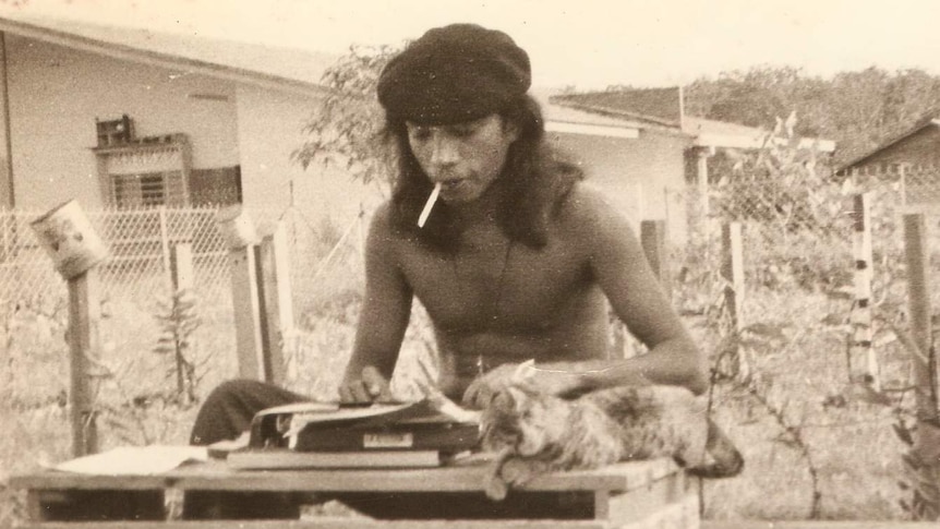 Malaysian poet and writer Salleh Ben Joned typing in the garden in Malaysia