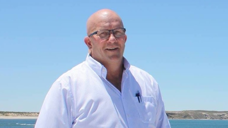 South Australian Trade Minister David Ridgway stands on a beach.