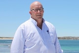 South Australian Trade Minister David Ridgway stands on a beach.