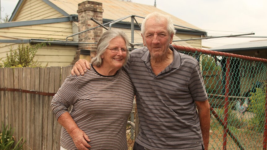 Pat Lawrence stands with her husband out the front of their Balmoral village house.