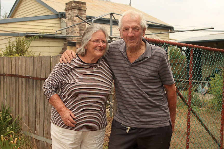 Pat Lawrence stands with her husband out the front of their Balmoral village house.