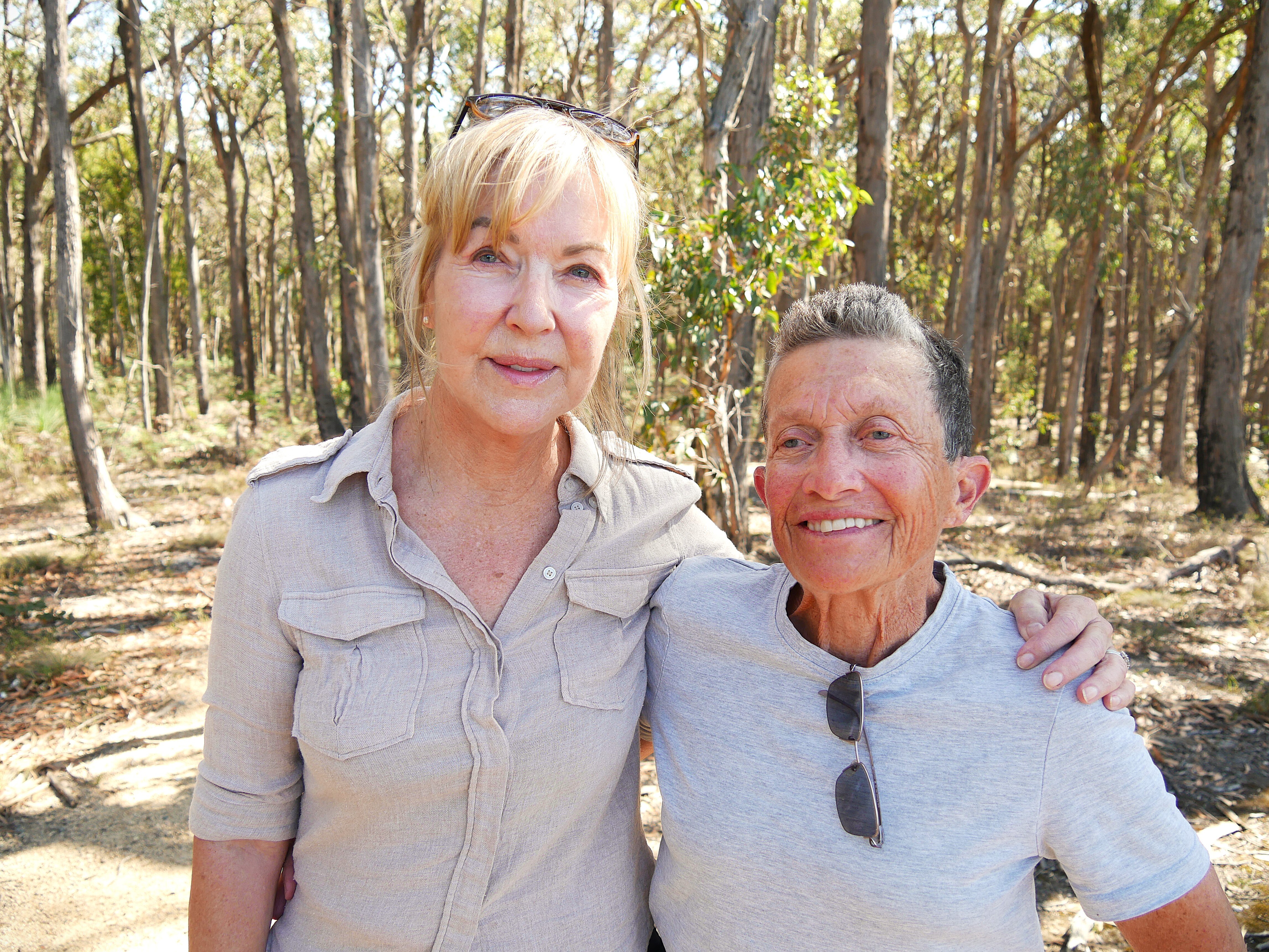 two women hugging in the bush. One has short grey hair and the other has long blonde hair.
