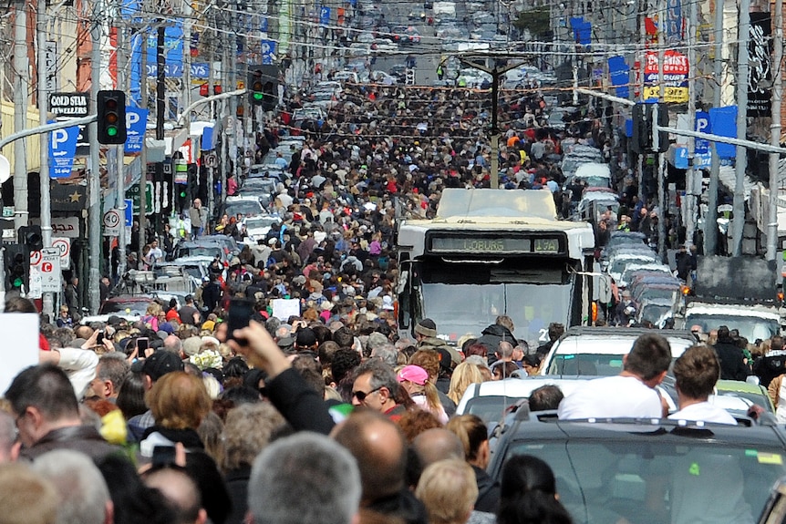 Thousands of people march along Sydney Road in Melbourne