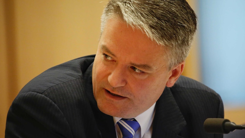 Finance Minister Mathias Cormann looks over his shoulder during Senate Estimates.