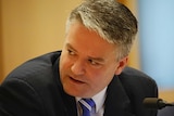 Finance Minister Mathias Cormann looks over his shoulder during Senate Estimates.