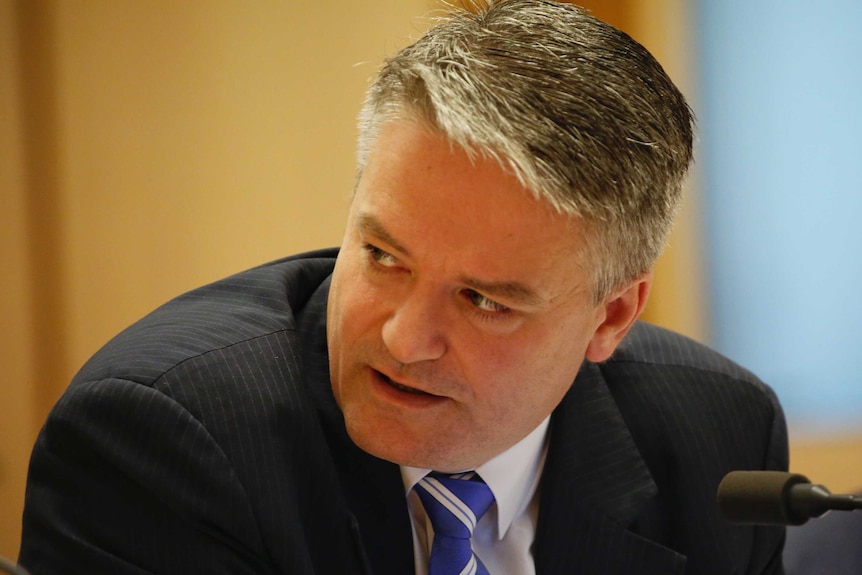 Finance Minister Mathias Cormann looks over his shoulder during Senate Estimates.