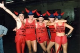 Five people stand together wearing red singlets at the 1988 Mardi Gras.