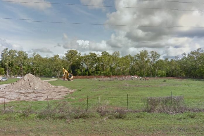 Google Maps street view of a block of land with a mound of dirty and an excavator in the background.