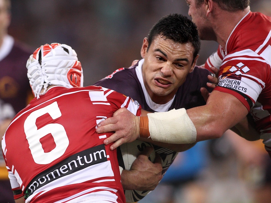 Ben Te'o of the Broncos takes on the Dragons defence.