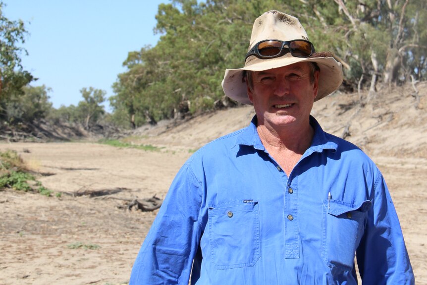 Cotton irrigator Tony Thompson stands in the dry riverbed of the Darling River at Bourke, New South Wales.