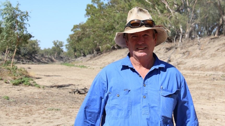 Cotton irrigator Tony Thompson stands in the dry riverbed of the Darling River at Bourke, New South Wales.