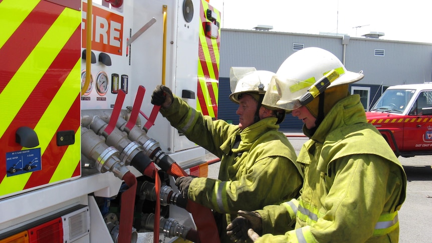 Tasmanian fire service pump truck with firefighters at rear