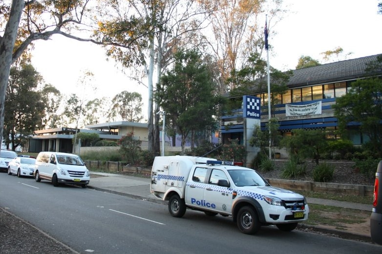 A police station with a van parked out the front