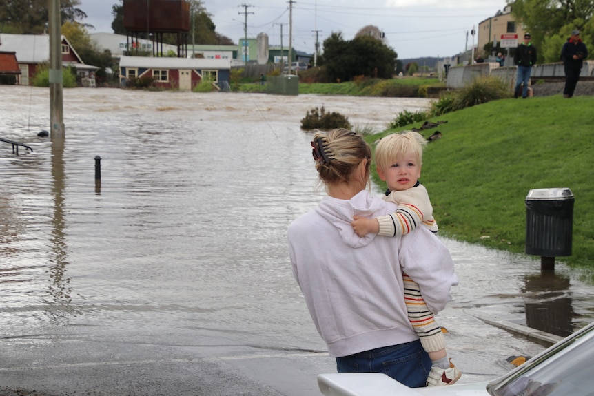 A mother and a child in the flood waters.