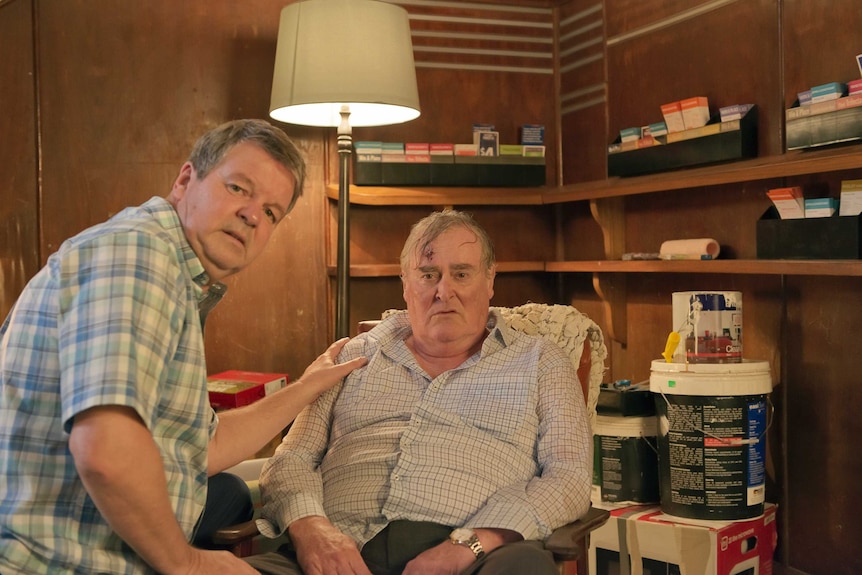 Actors Kevin Harrington and John Howard look at the camera while seated in Seachange