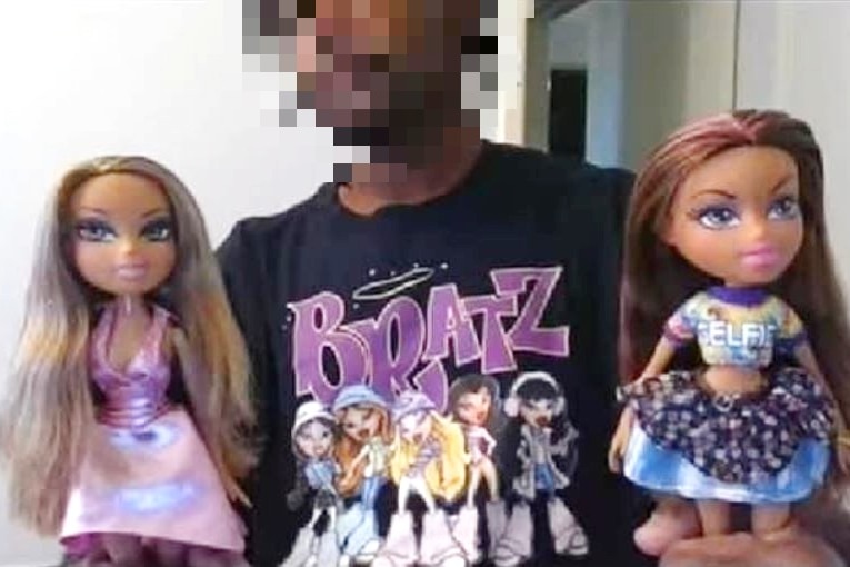 A man holding Bratz dolls with his face pixelated