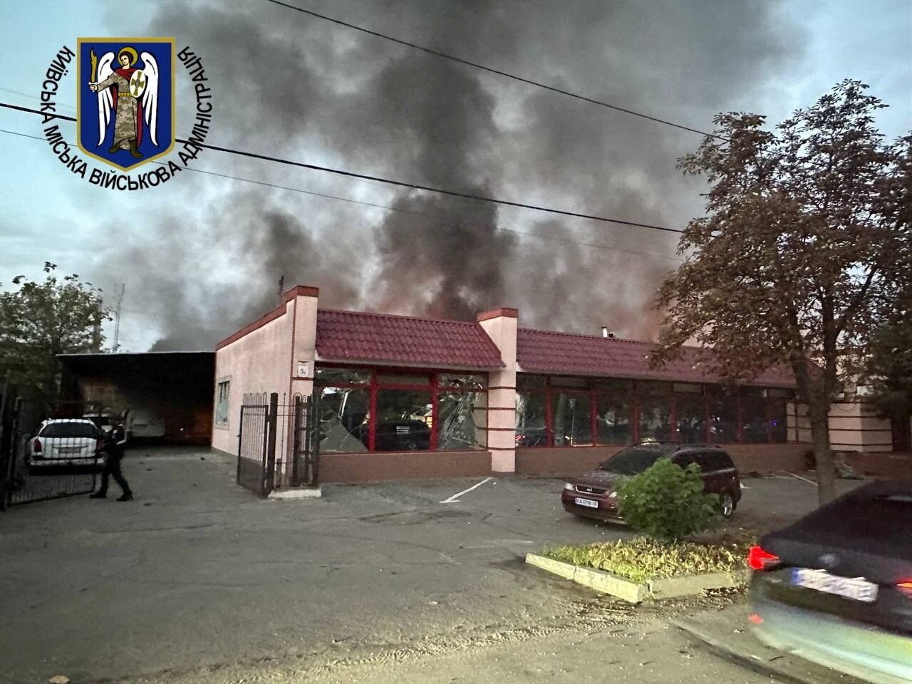 Smoke rises from a red tiled building 