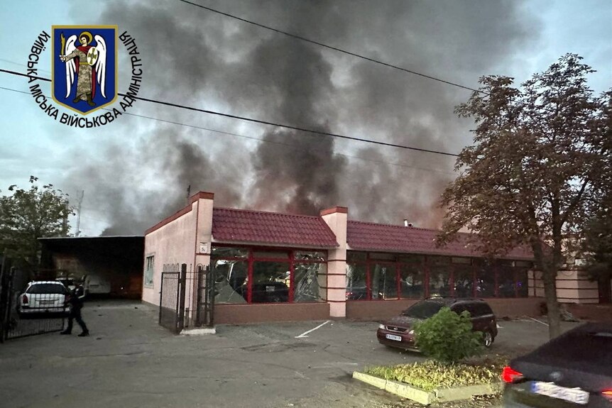 Smoke rises from a red tiled building 
