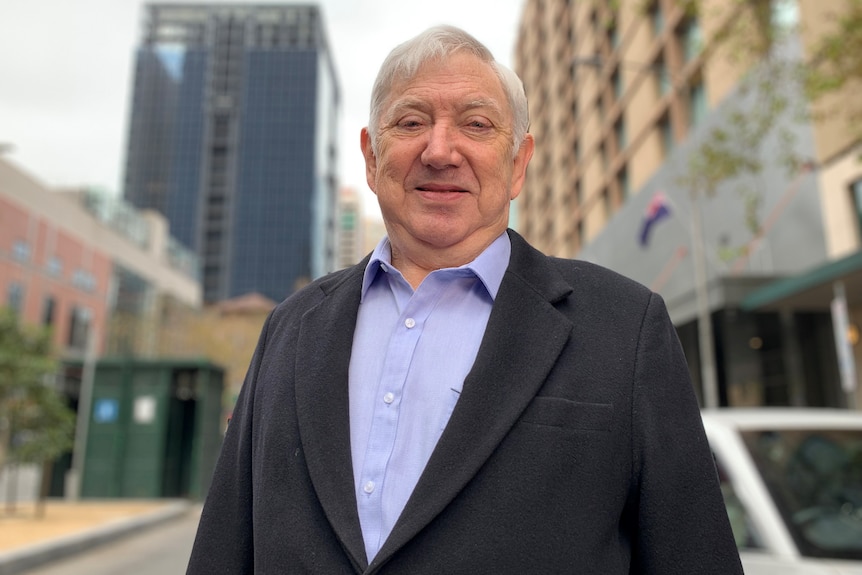 A man in a suit in a cityscape