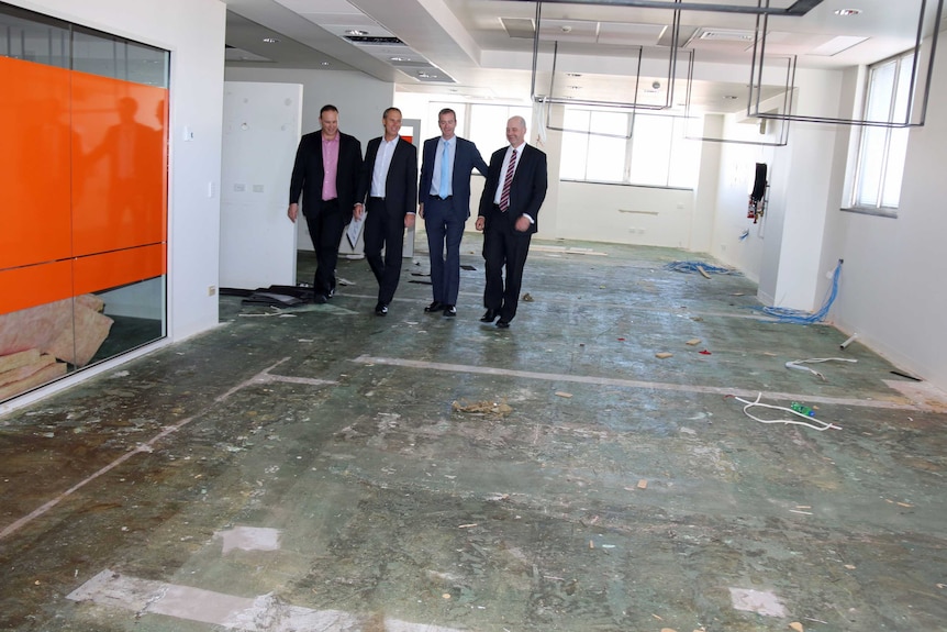 (l-r) Project manager, Wade Harrison;  Contractor, Craig Edmonds;  Health Minister Michael Ferguson, and senior clinician, John Burgess  inspect disused office space at Royal Hobart Hospital which will be converted into a respiratory and infectious diseases unit.