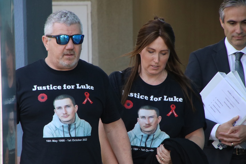 Two people wearing remebrance T-shirts.