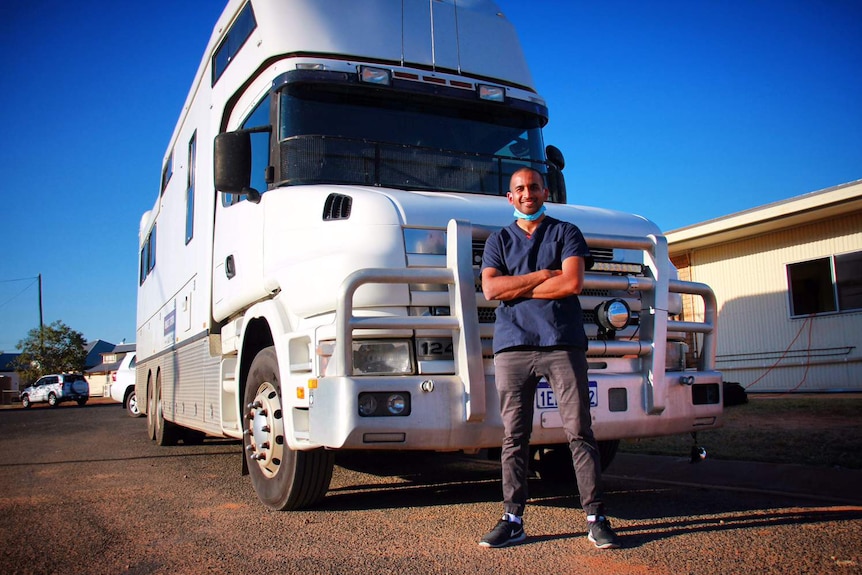 Sydney dentist Dr Jalal Khan stands in front of his truck in an outback Queensland town