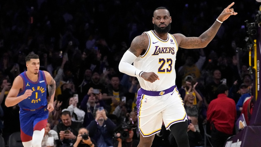 LeBron James gestures with his left hand after becoming the first NBA player to reach 40,000 points.