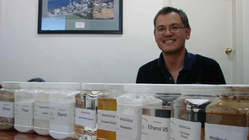 Site manager Ming Leung sits behind a long row of products from the Manildra plant including wheat, flour, gluten and starch.