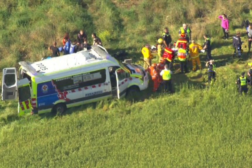 An ambulance and numerous people.