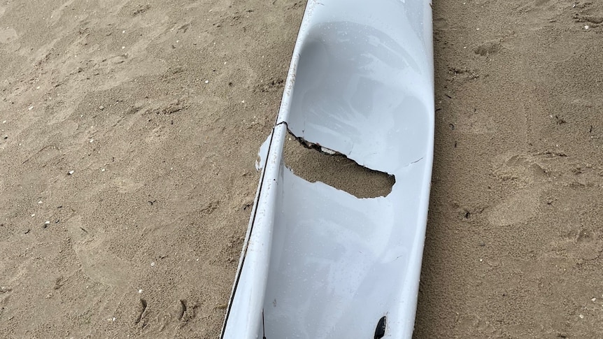 A fibreglass surf ski with a hole in it