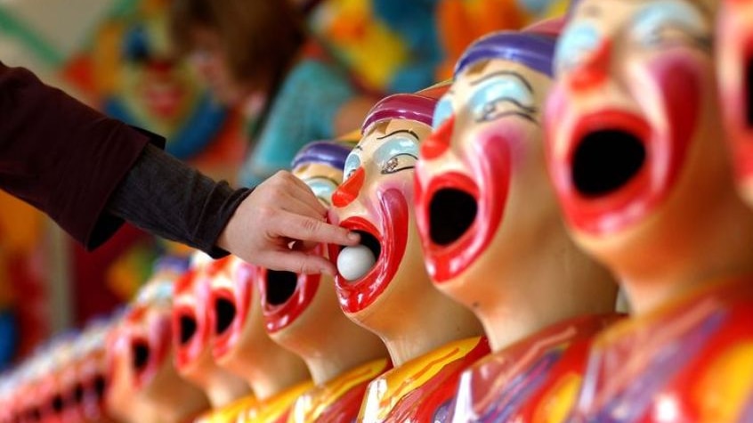 Carnival clowns with laughing faces in arcade game