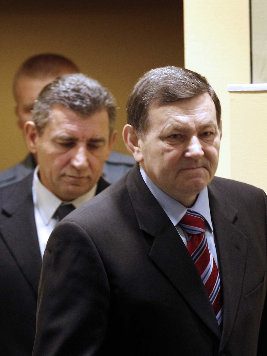 Former Croatian army generals Mladen Markac and Ante Gotovina walk into court.