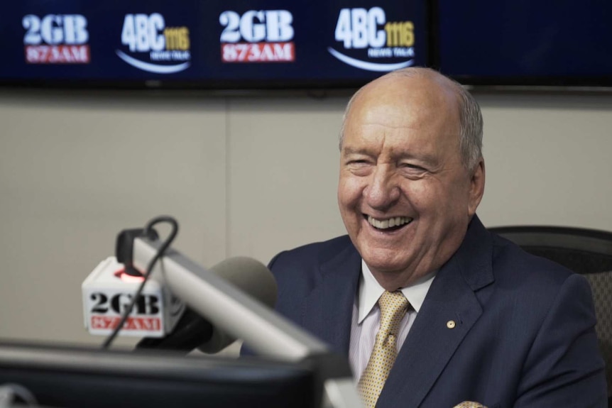 Alan Jones behind microphone