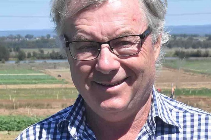 Town planner Ian Sinclair standing with farming land behind him.