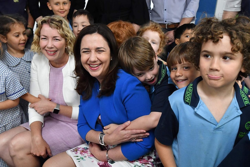 Annastacia Palaszczuk gets a hug from a prep student at Bardon State School during a visit in the election campaign.