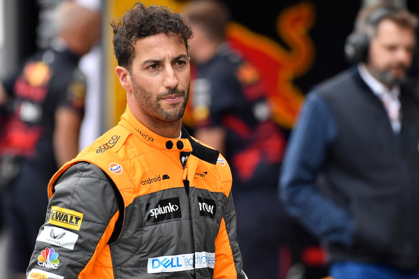 Daniel Ricciardo walking through the pit lane. 