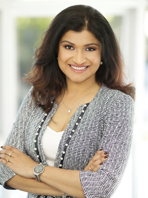 Dr Padma Gadiyar stands with her arms folded 