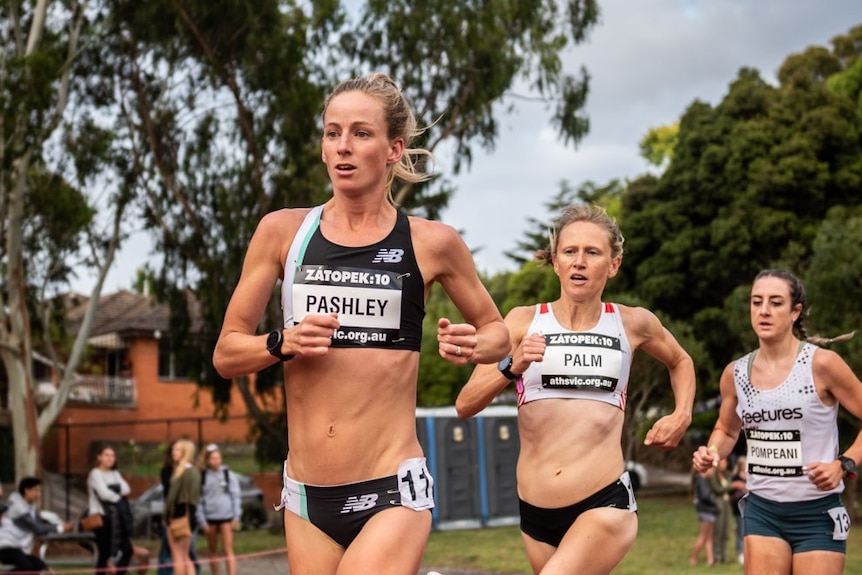 Three women running in athletics gear 