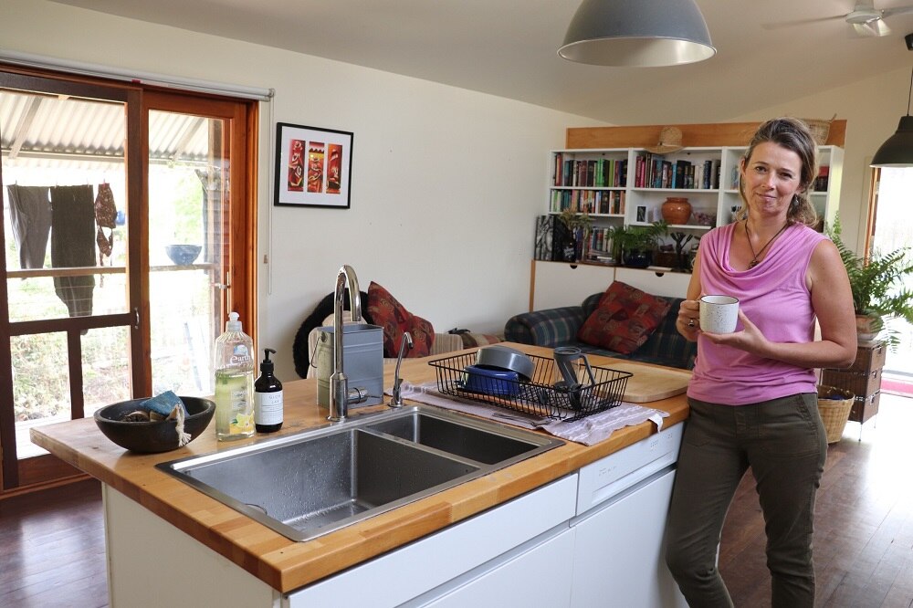 Emma Hohnen standing inside a house.