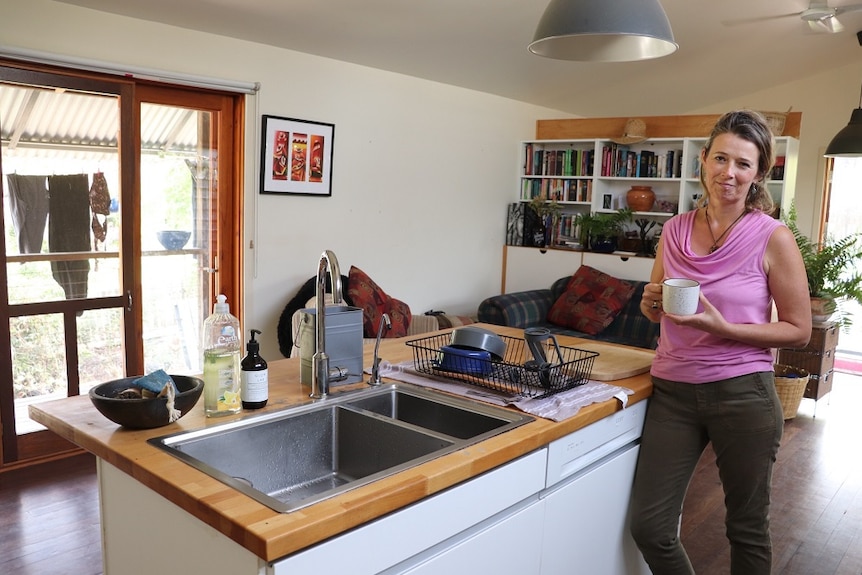 Emma Hohnen standing inside a house.