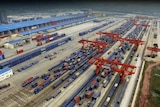 The logistics centre in the city of Chongqing, showing rows of shipping containers and the cranes to move them onto trains.