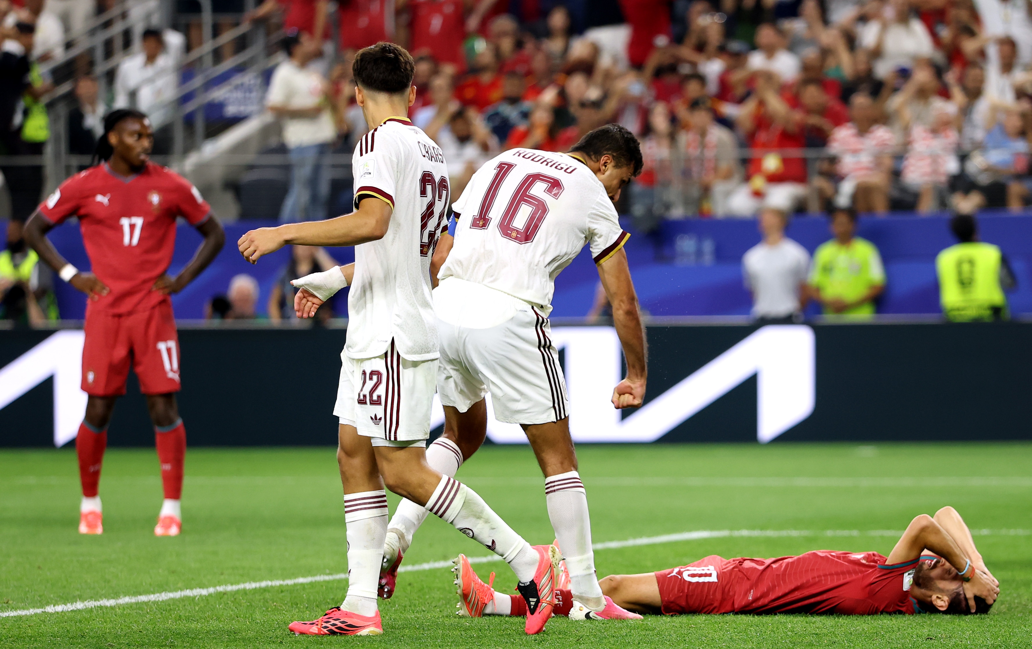 Rodri stands over and gestures towards Bernardo Silva, who is down on the ground