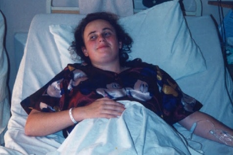 Rebel Wilson, as a teenager, in a hospital bed.