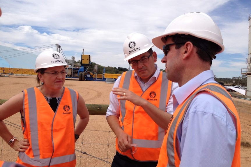 Victorian Transport Minister Jacinta Allan, Prime Minister Daniel Andrew and Lance Brown of GrainCorp next to the rail freight line.